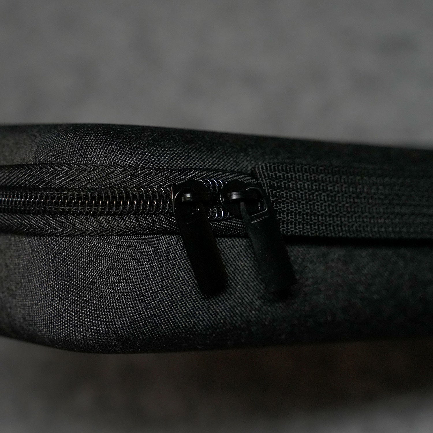 Close-up of a Akko Keyboard Carrying Case on a textured black surface